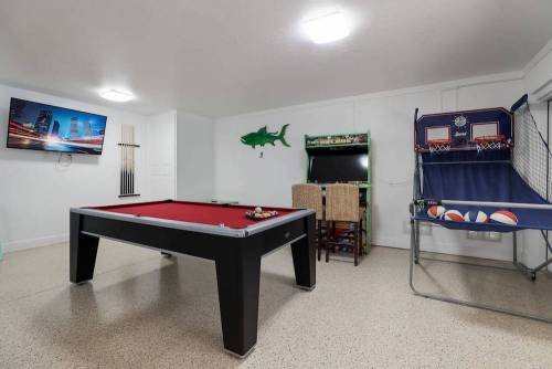 Vacation rental game room with a pool table, basketball game, and video game